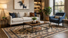 A well-furnished living room showcasing a comfortable sofa, a stylish chair, and a patterned rug.